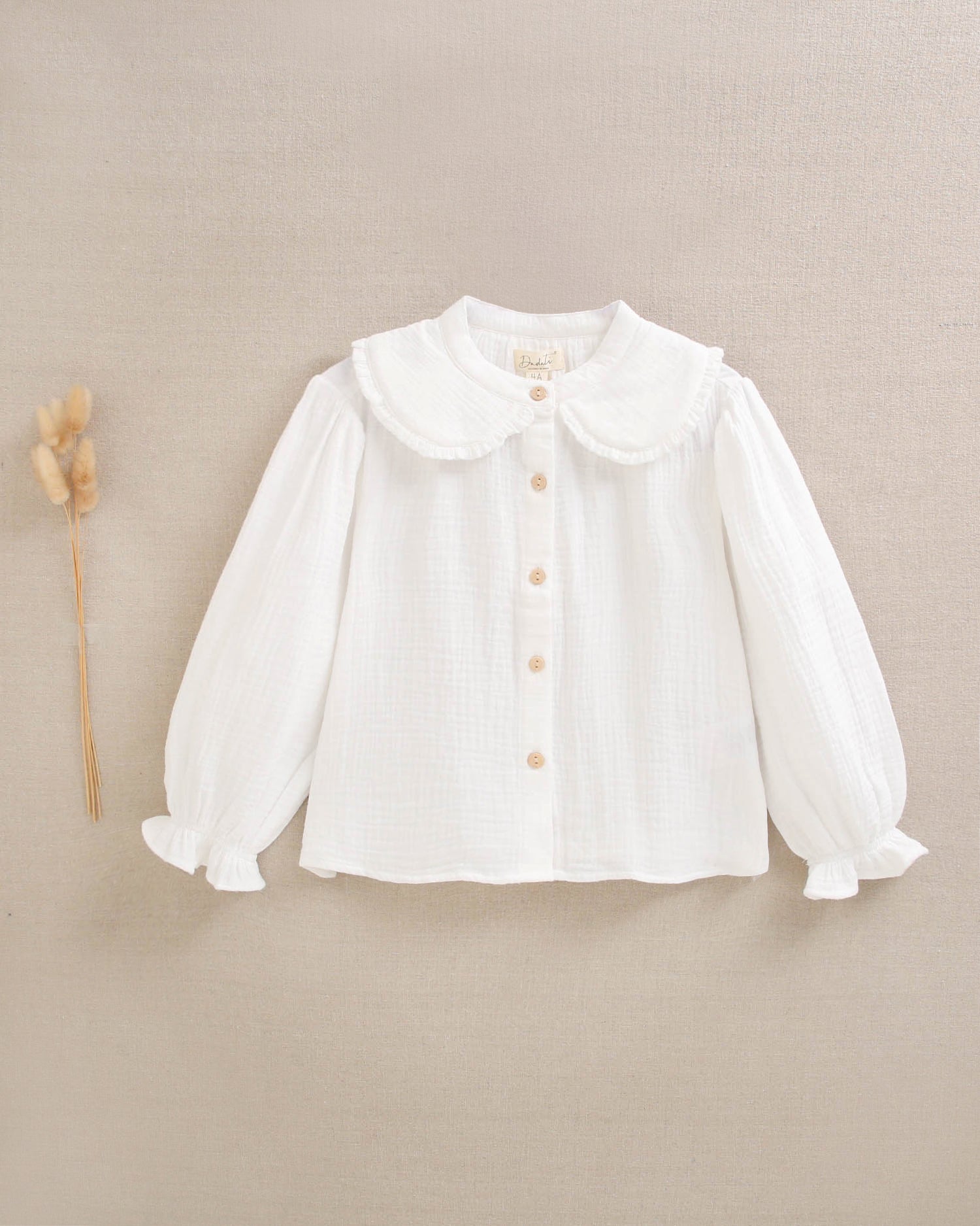 Blusa de niña de muselina blanca con cuello Peter Pan