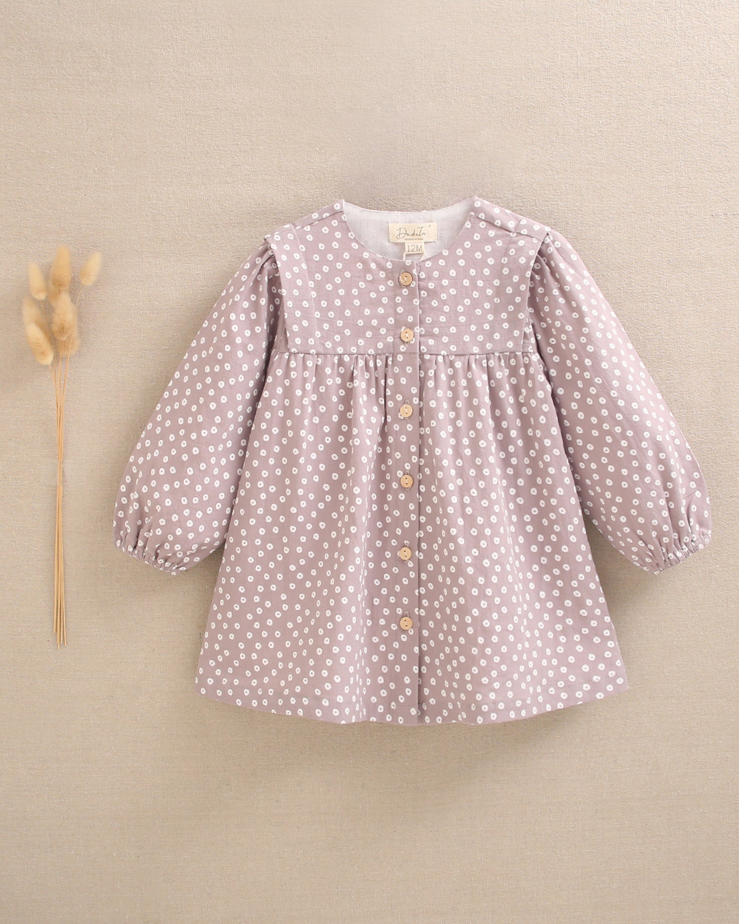Vestido de bebé niña malva con estampado geométrico