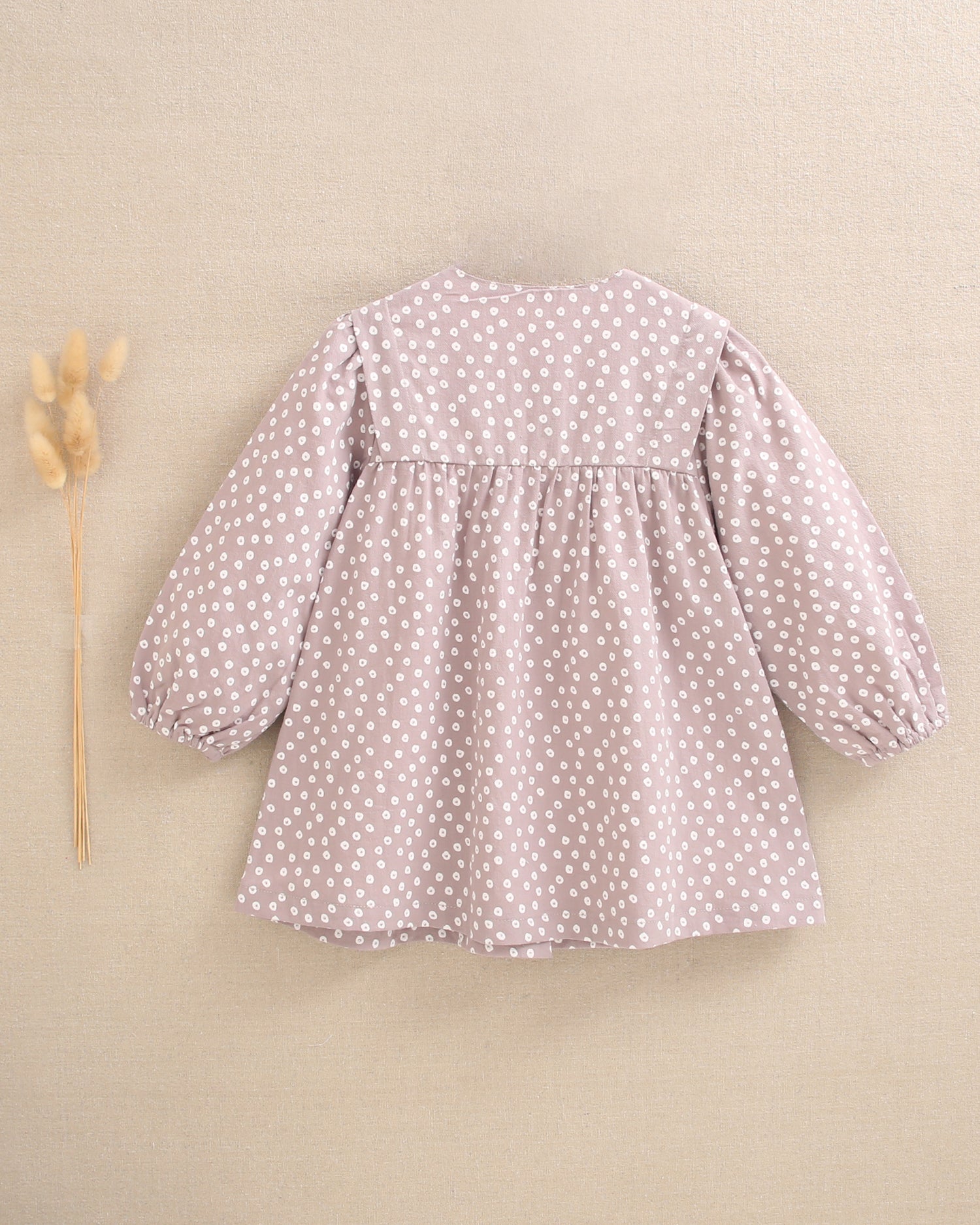Vestido de bebé niña malva con estampado geométrico