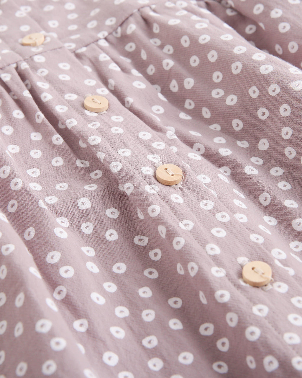 Vestido de bebé niña malva con estampado geométrico