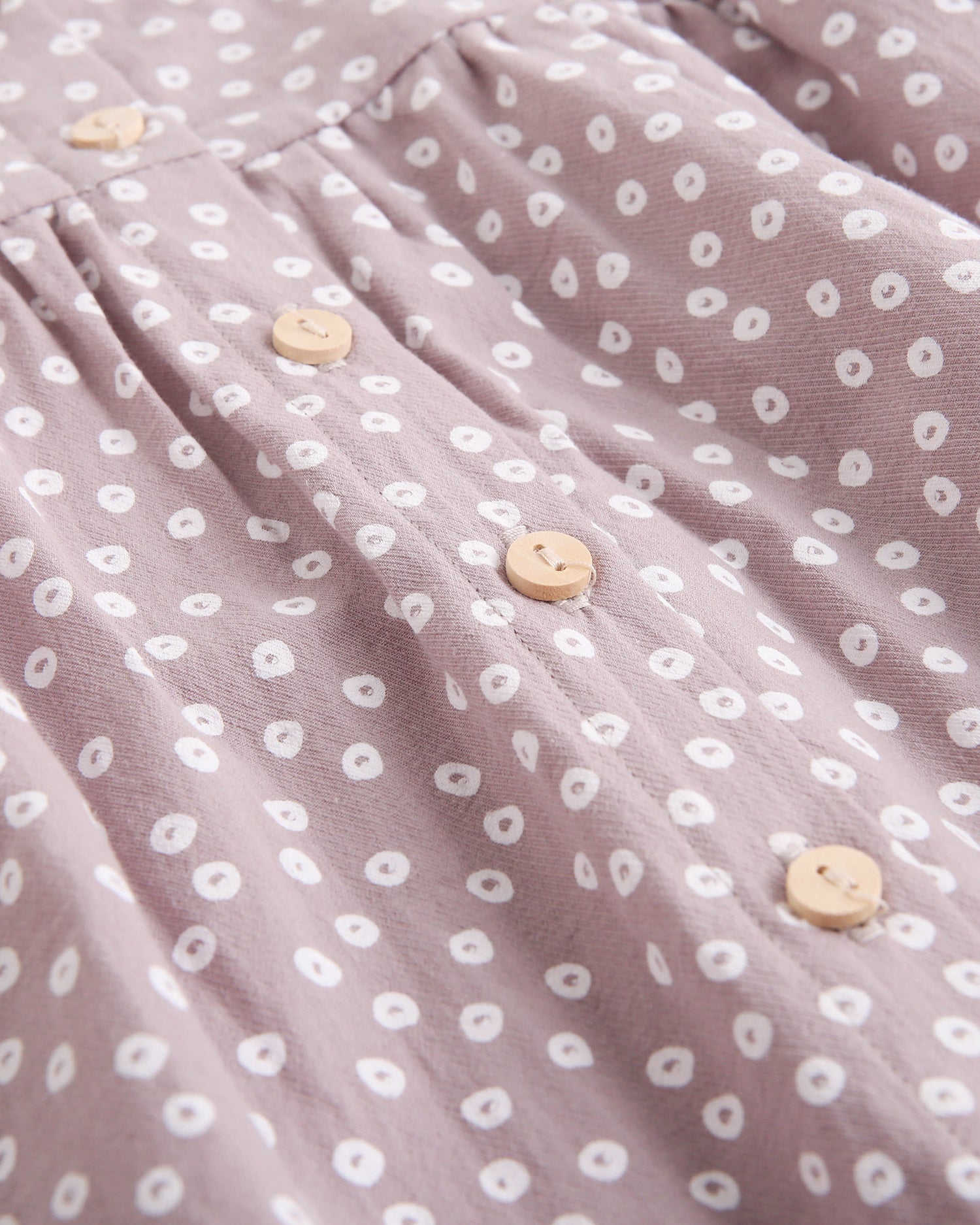 Vestido de bebé niña malva con estampado geométrico