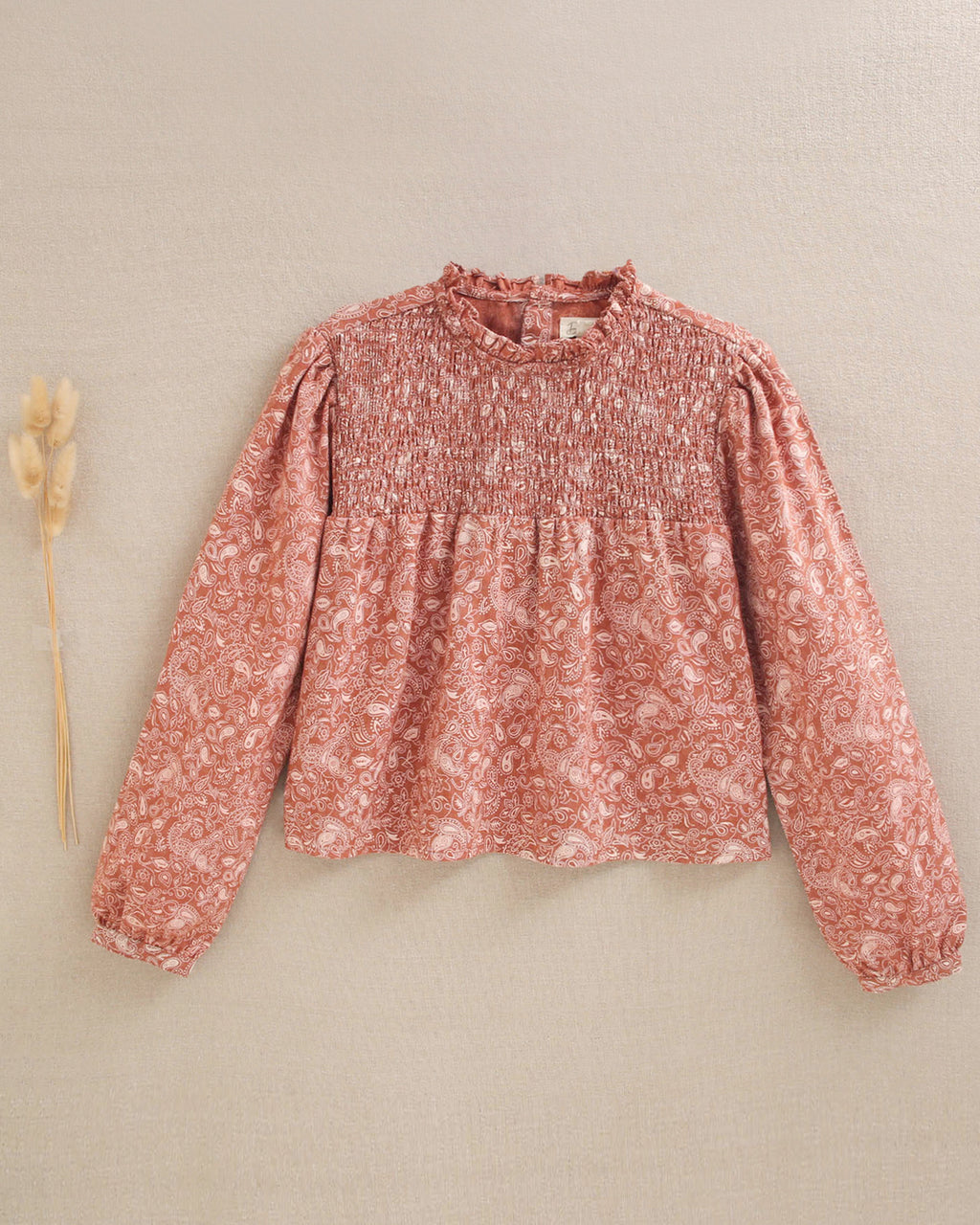 Blusa de niña teja con estampado geométrico