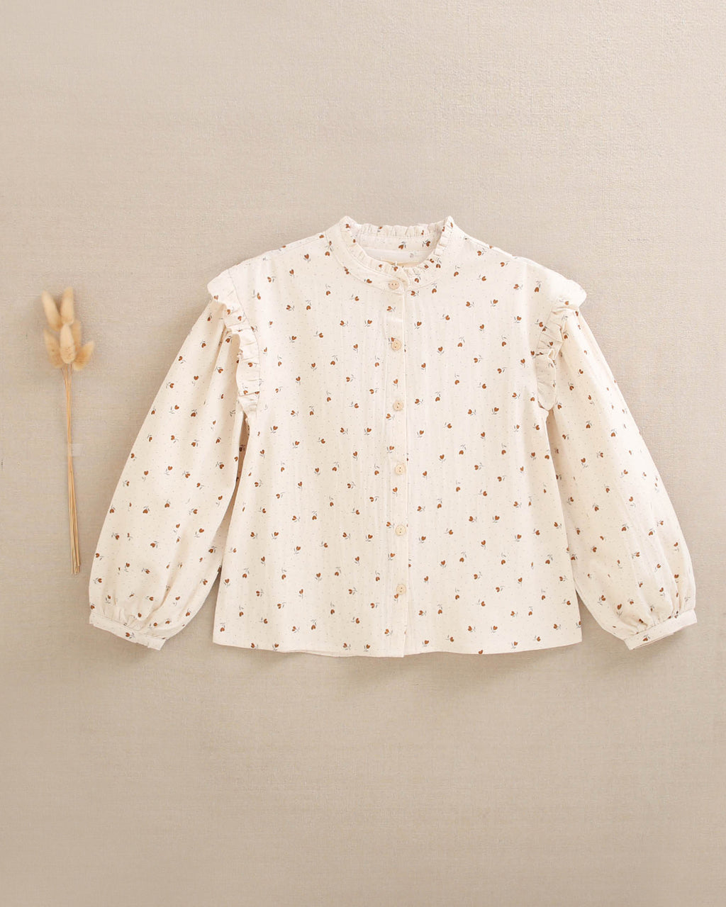Blusa de niña beige con flores marrones