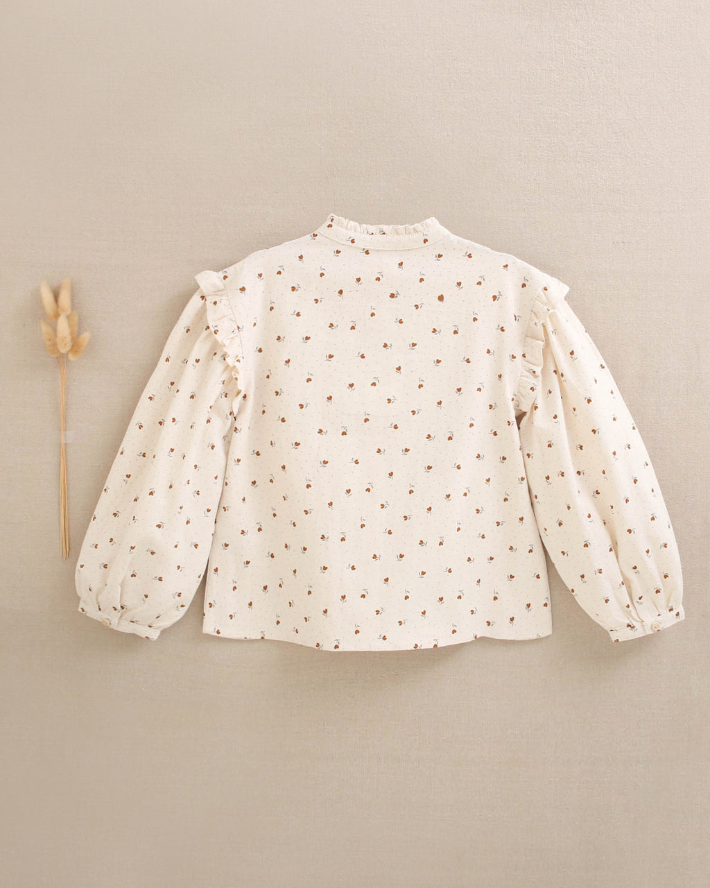 Blusa de niña beige con flores marrones