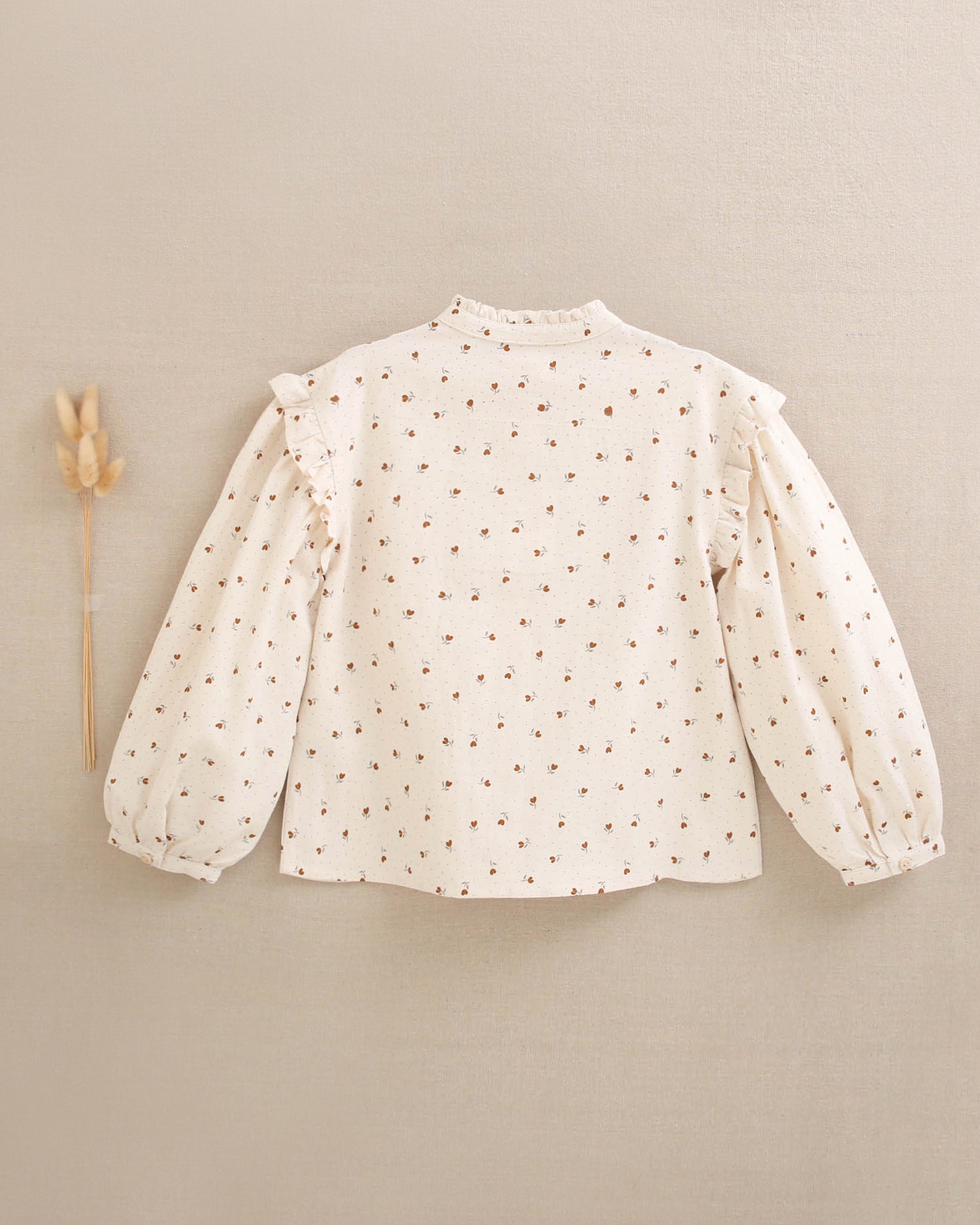 Blusa de niña beige con flores marrones