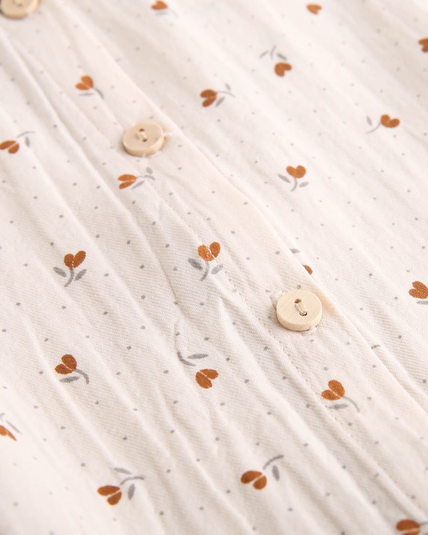 Blusa de niña beige con flores marrones