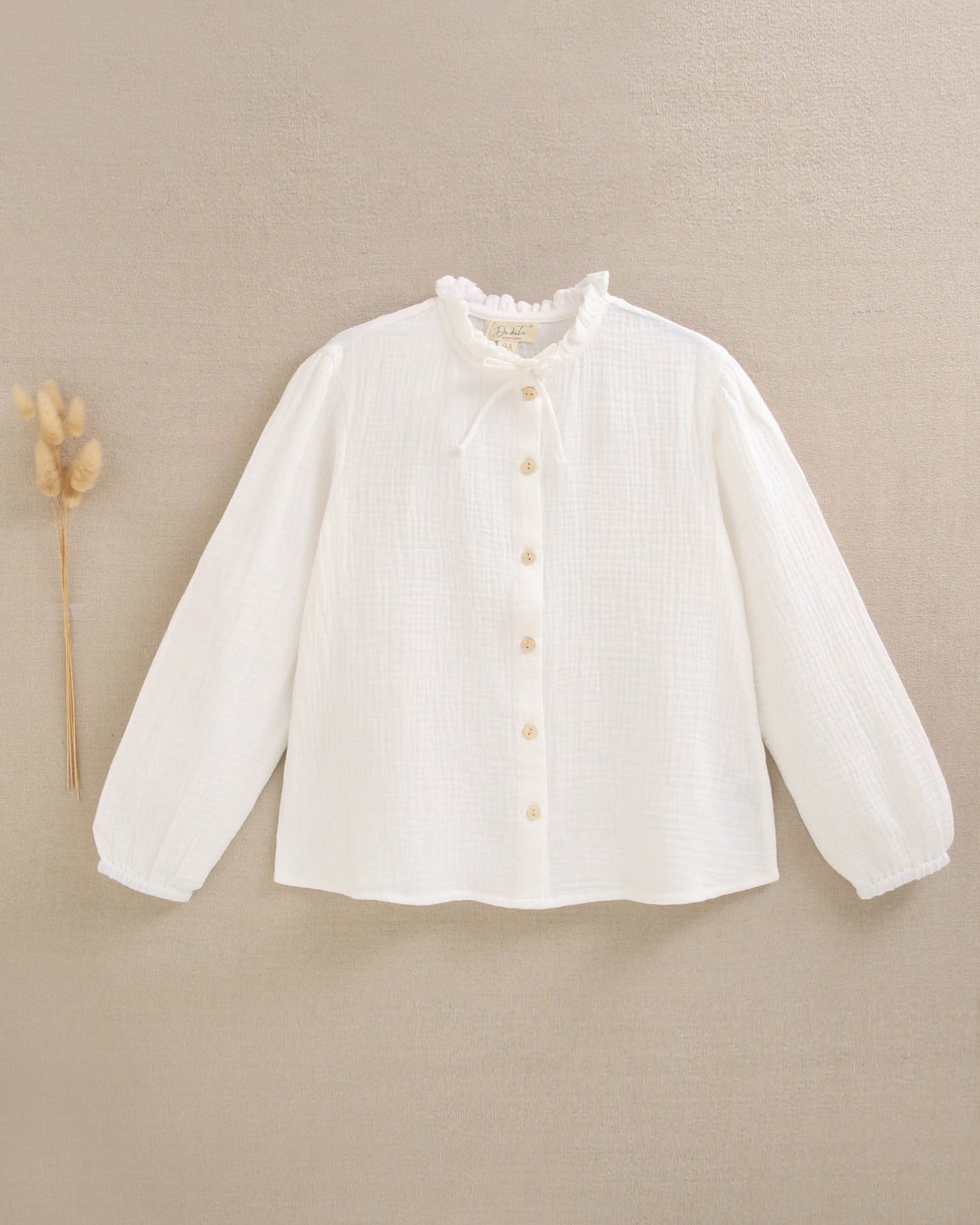 Blusa de niña de muselina blanca con cuello Peter Pan