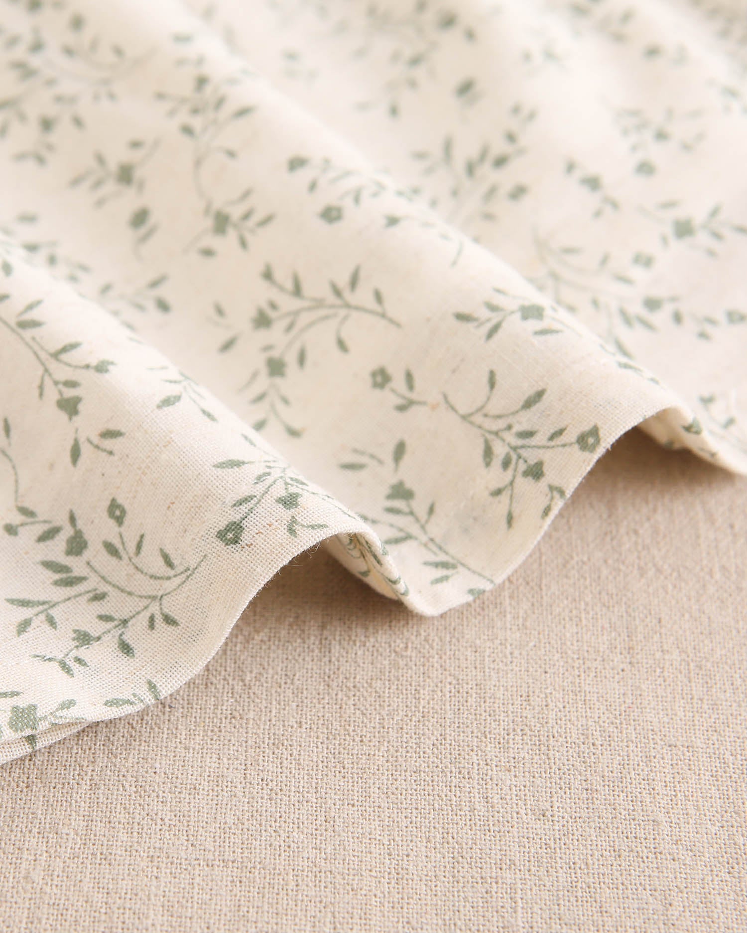 Vestido de niña color crudo con estampado floral verde y detalle de volante