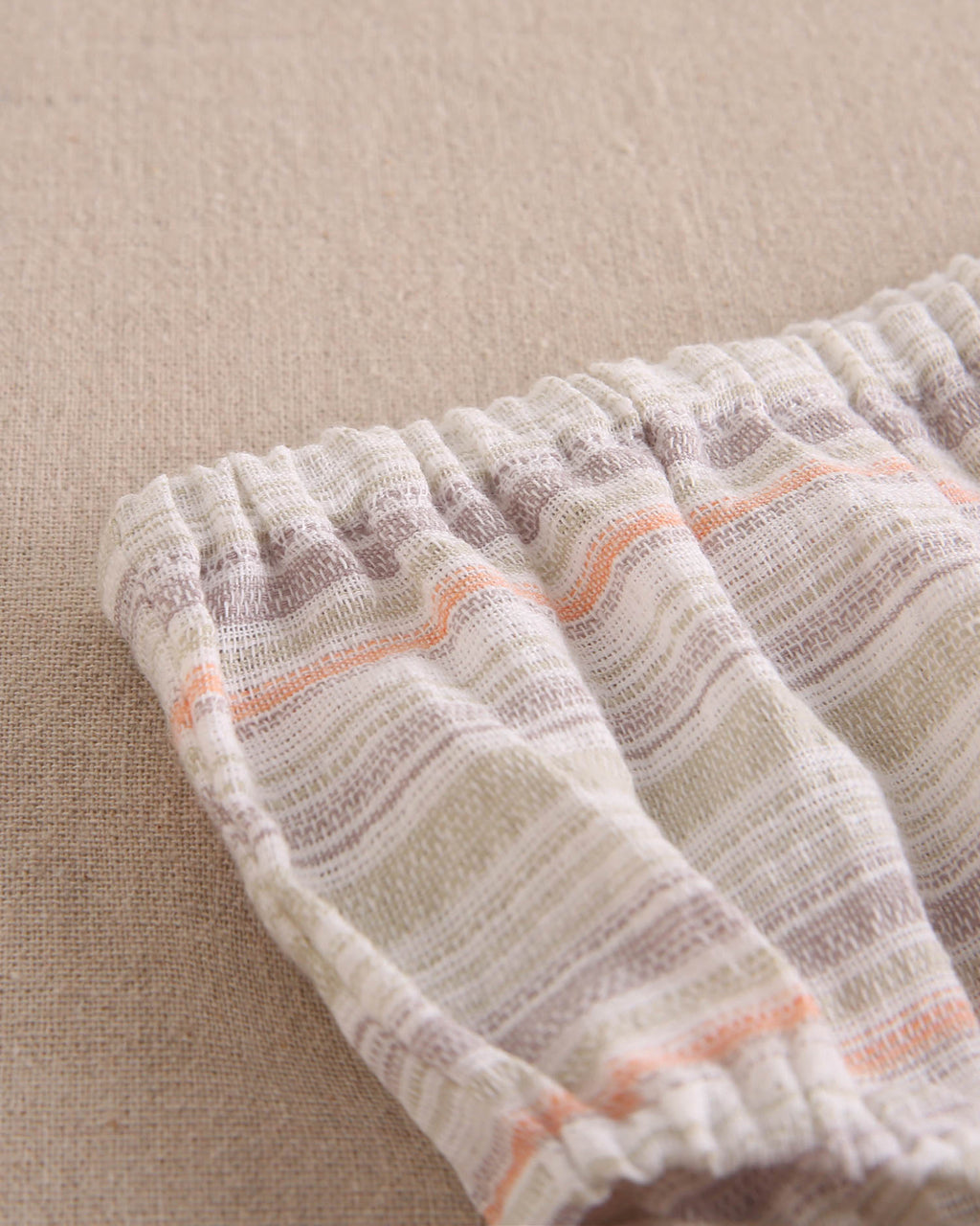 Vestido bebé niña rayas naranja, gris y verde, con borla naranja flúor