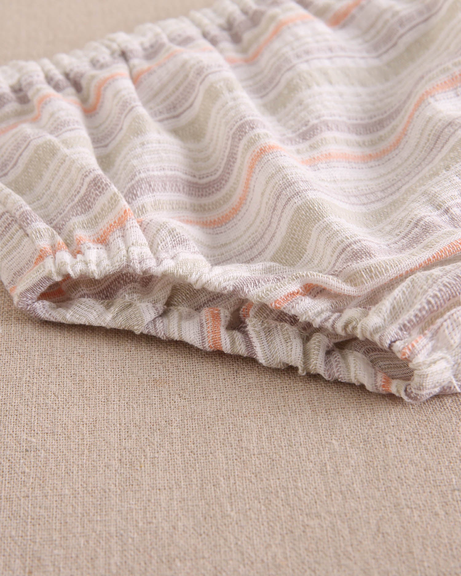 Vestido bebé niña rayas naranja, gris y verde, con borla naranja flúor