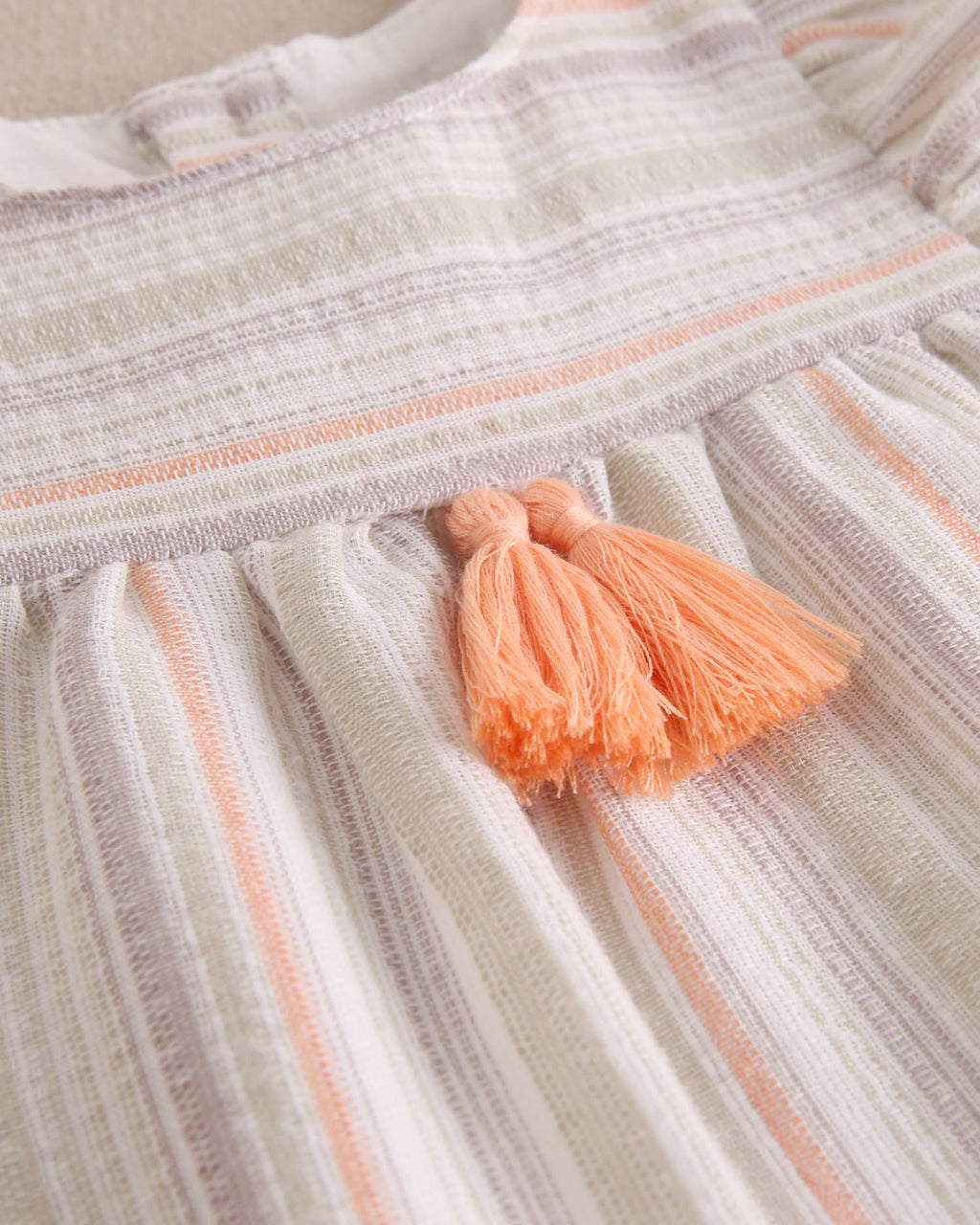 Vestido bebé niña rayas naranja, gris y verde, con borla naranja flúor