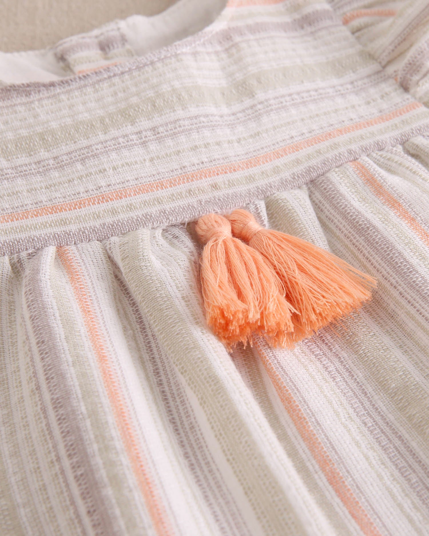 Vestido bebé niña rayas naranja, gris y verde, con borla naranja flúor