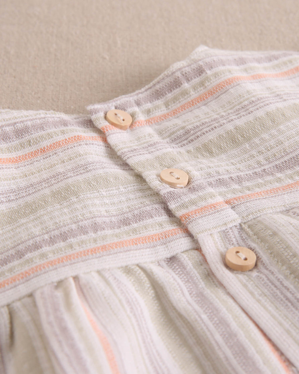 Vestido bebé niña rayas naranja, gris y verde, con borla naranja flúor