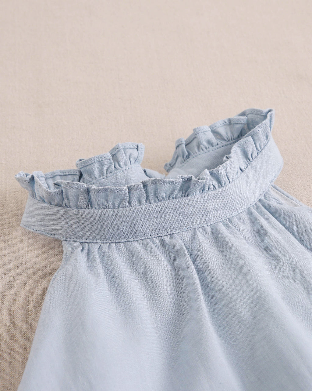 Enterito niña azul con cuello halter y nudo