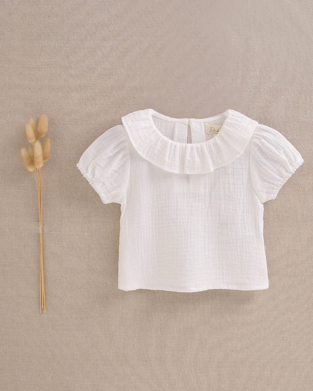 Blusa de bebé niña de muselina blanca con manga abullonada