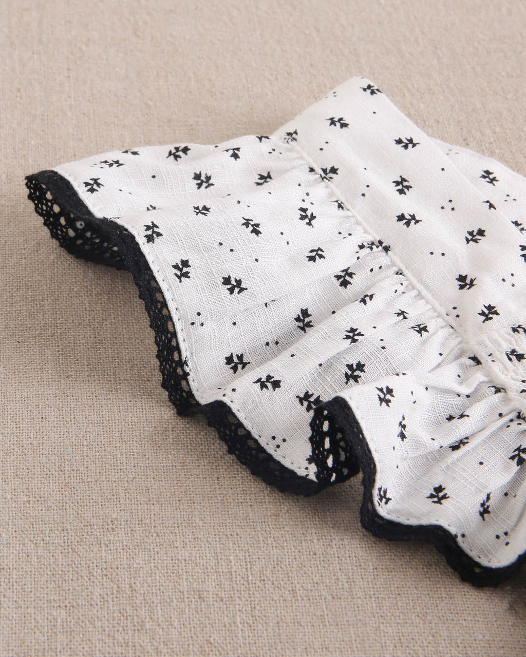 Vestido niña blanco con flores negras y mangas con bordes negros