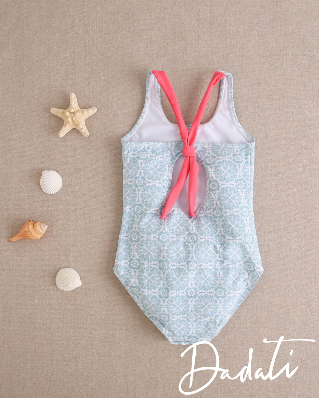 Traje de baño niña celeste con tiras rosadas