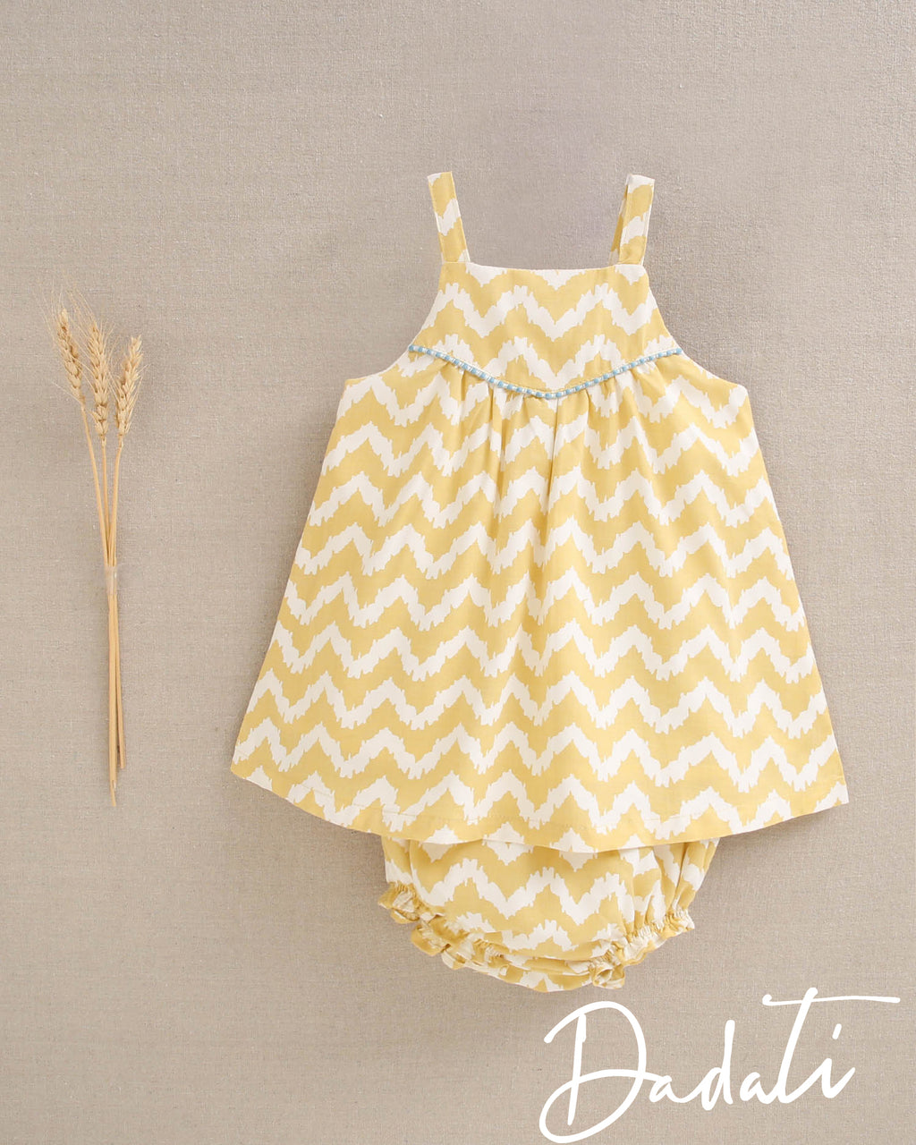 Vestido bebé niña amarillo con zigzag blanco