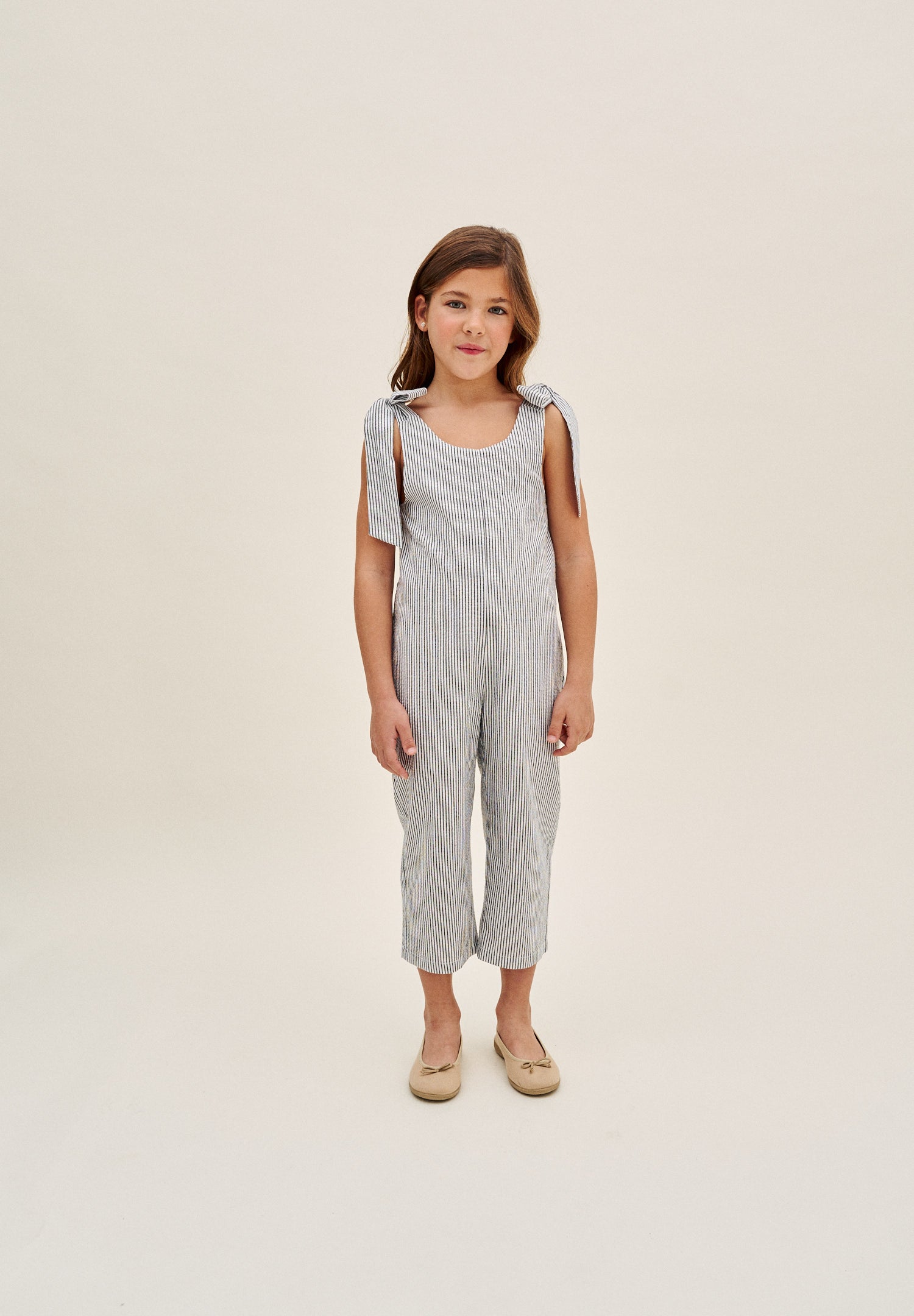 Enterito niña en rayas negras y azul marino con lazadas