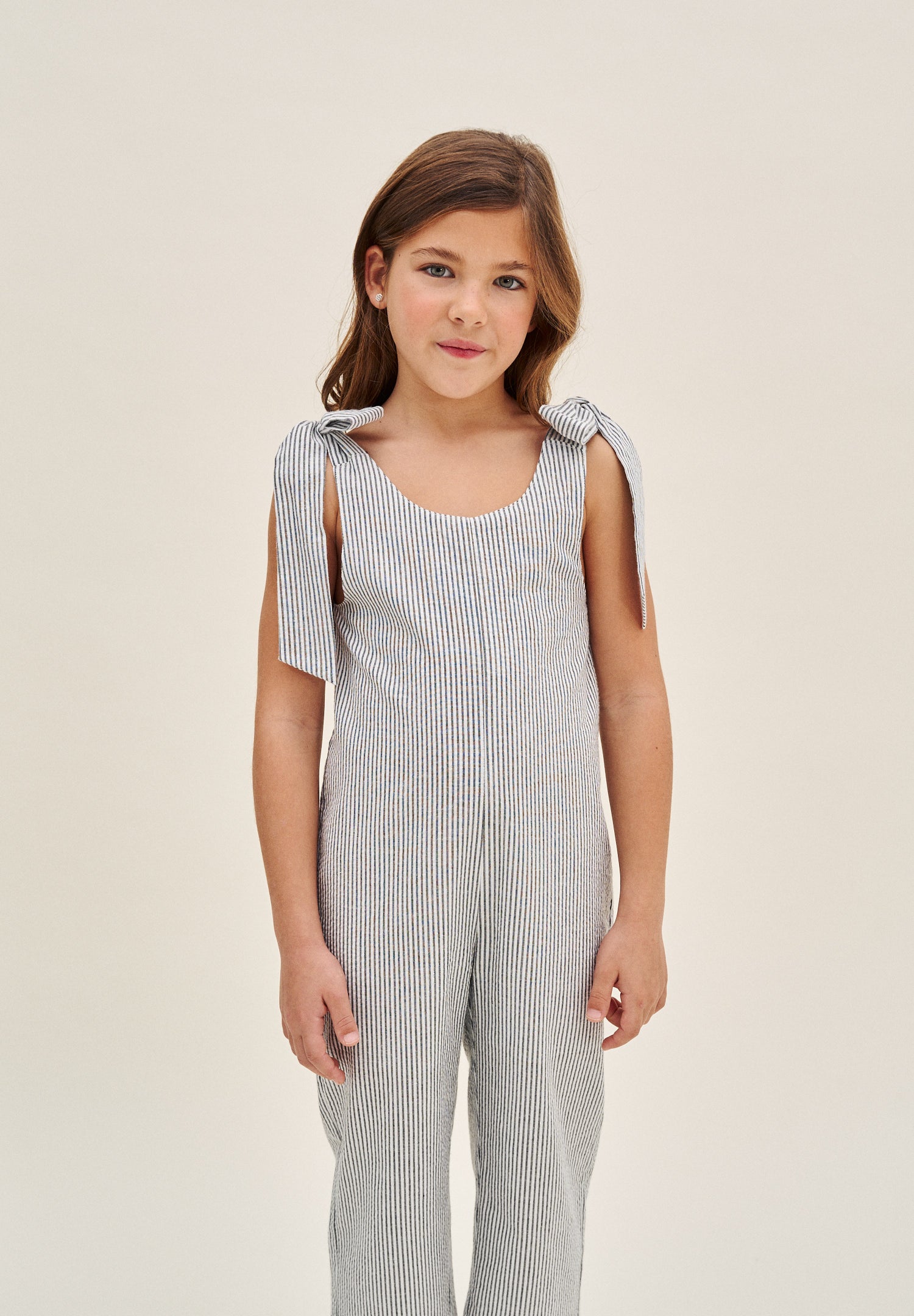 Enterito niña en rayas negras y azul marino con lazadas