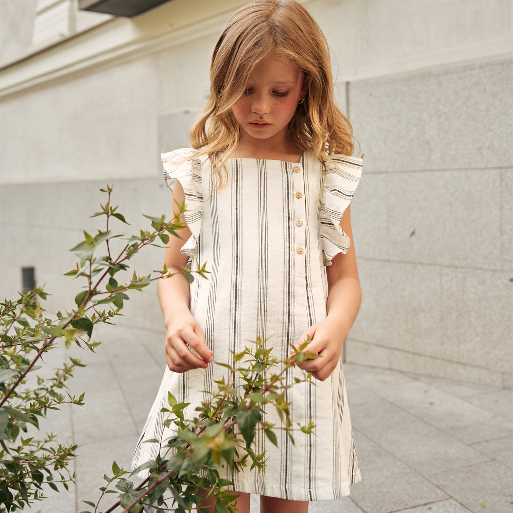 Vestido de niña en rayas negras y blancas y lazo negro en espalda
