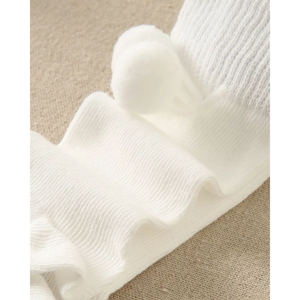 Calcetín bebé blanco con borla