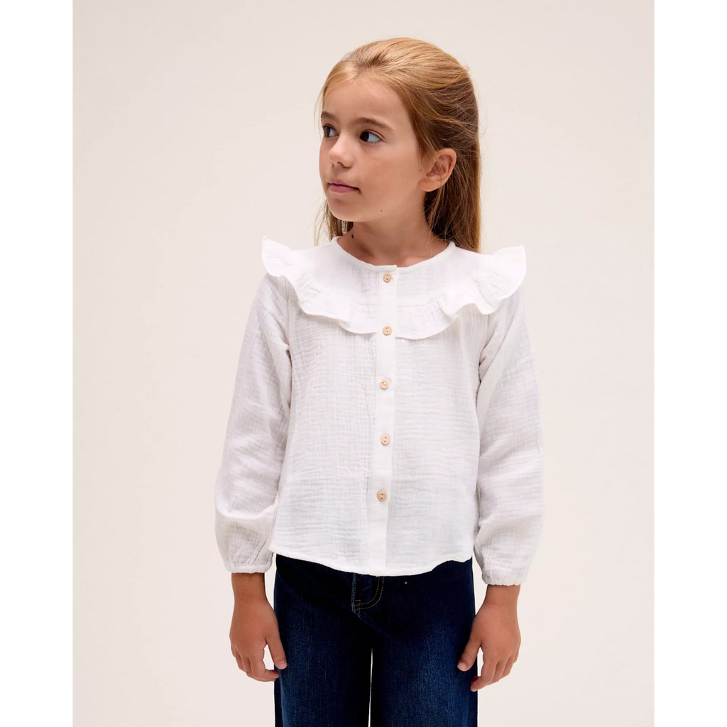 Blusa manga larga de niña en blanco con volante