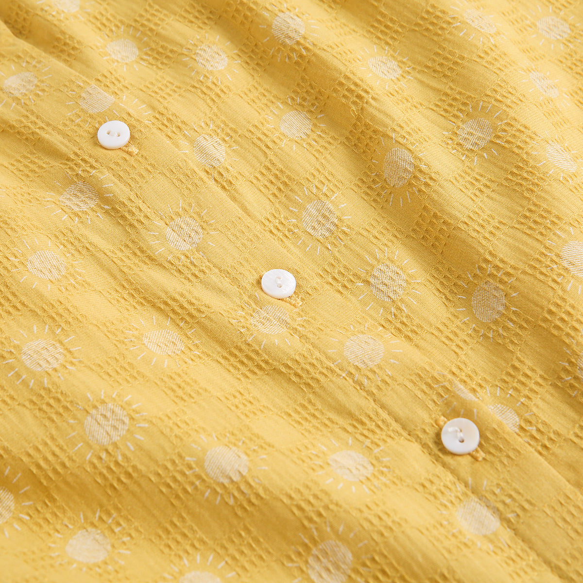 Vestido de niña amarillo mostaza con estampado de soles