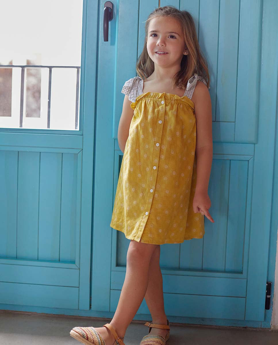 Vestido de niña amarillo mostaza con estampado de soles