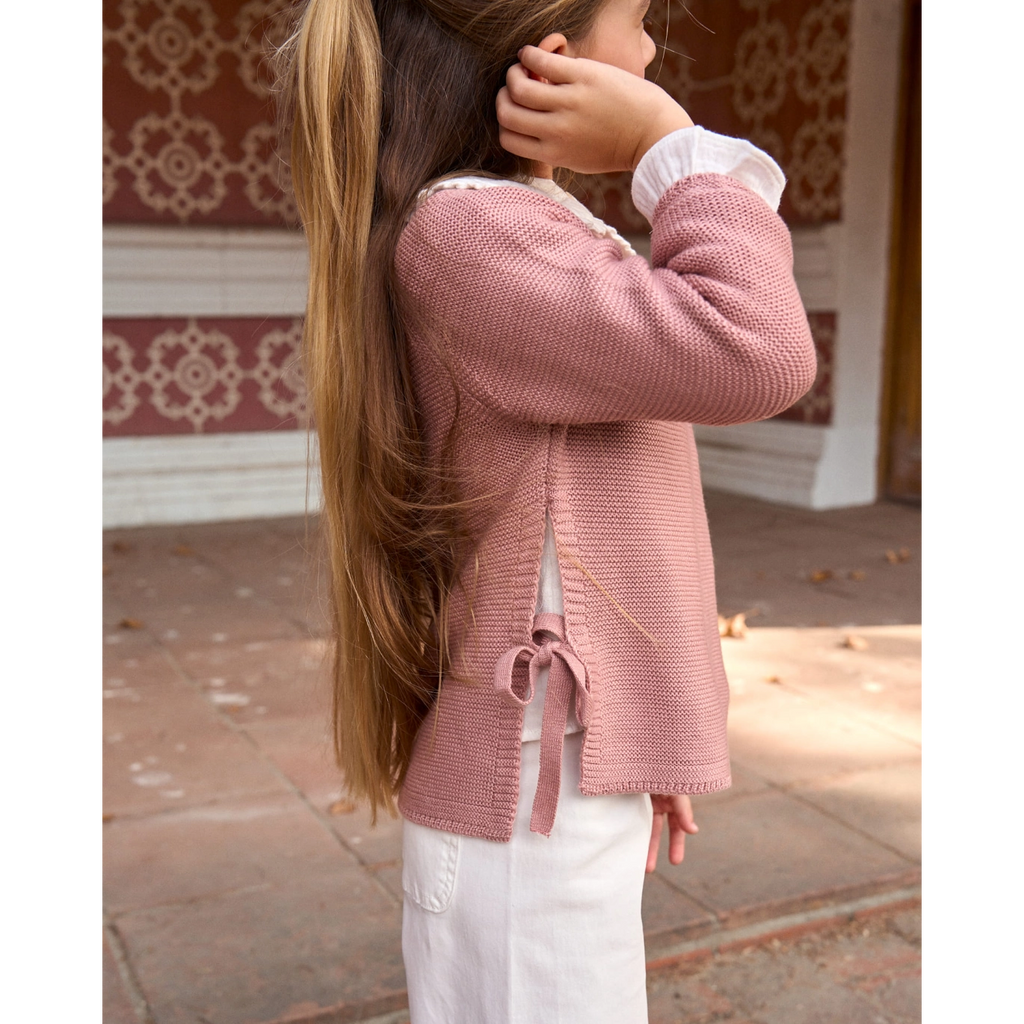 Jersey de niña de punto en rosa con lazos laterales