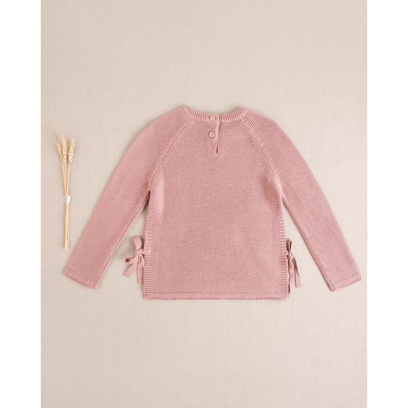 Jersey de niña de punto en rosa con lazos laterales