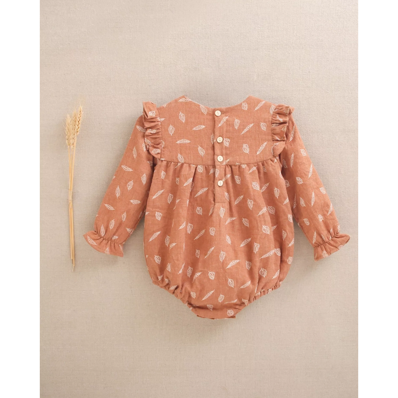 Ranita de bebé niña teja con estampado y detalle de borla