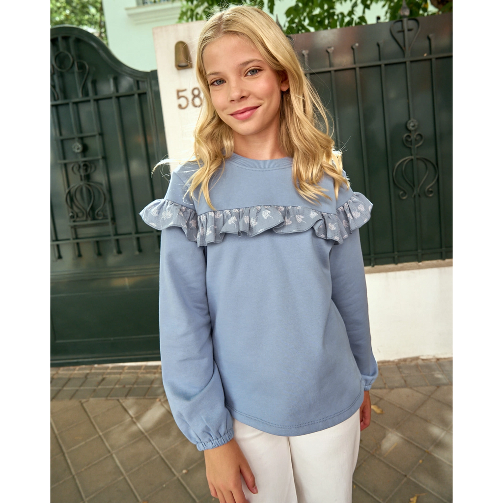 Polerón de niña azul con detalle de volante