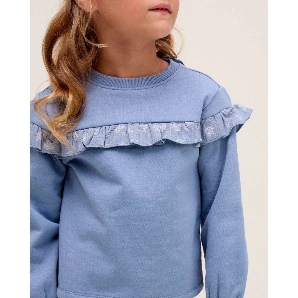 Polerón de niña azul con detalle de volante