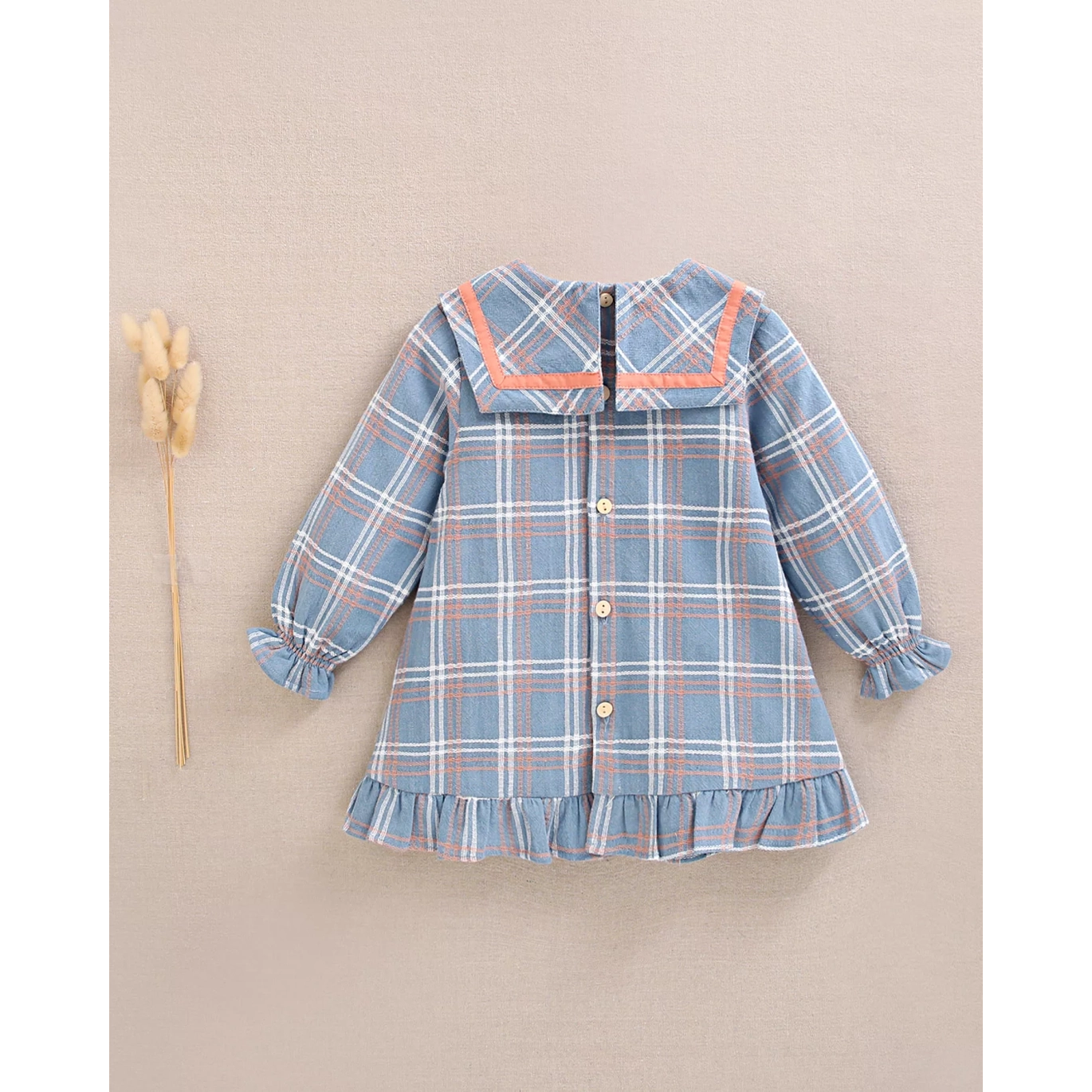 Vestido de bebé niña azul con detalle lazo y ribete naranja